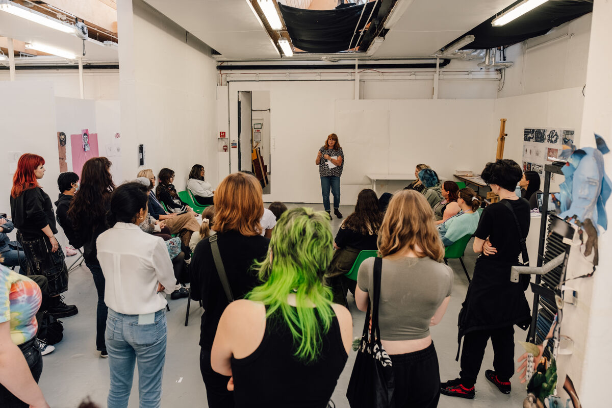 Lecturer talking to students in a fine art studio